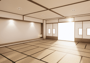 A spacious, well-lit traditional Japanese tatami room with wooden accents, sliding doors, and soft lighting from lanterns.