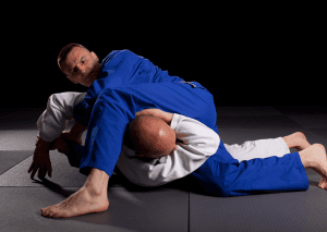 BJJ practitioners in a complex grappling exchange, demonstrating advanced BJJ positions during ground training.