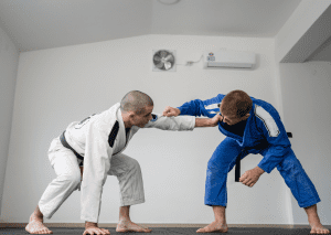 Two BJJ practitioners gripping each other's gi, demonstrating standing positions in BJJ during a training session.