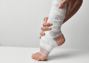 Close-up of a person's foot wrapped in a white bandage, indicating an injury or recovery process.