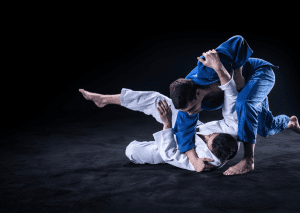 Two judo practitioners in gis performing a dynamic throw during training.