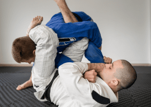 Students practicing submission techniques at jiu-jitsu schools, demonstrating grappling skills and body control.